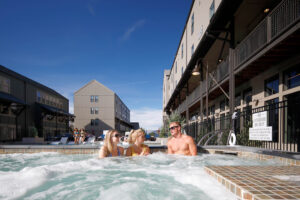 College aged residents enjoying hot tub and swimming pool