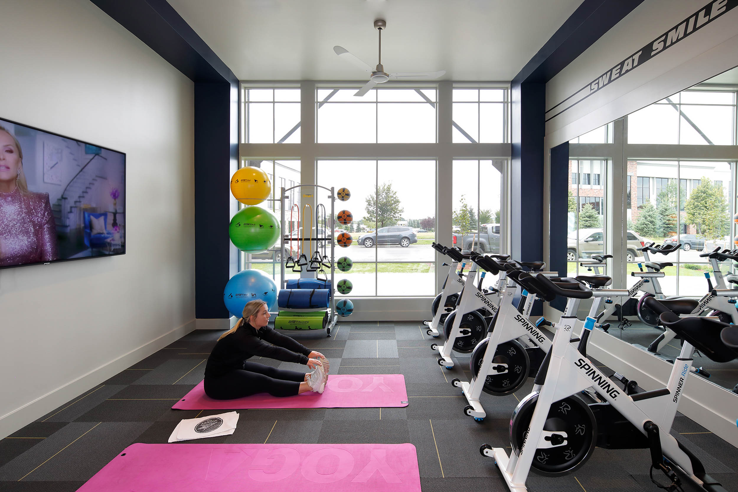 Fitness center with yoga mats and stationary bikes