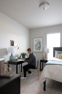 Guy working at desk in bedroom