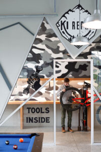 Resident working on bicycle in bike repair shop