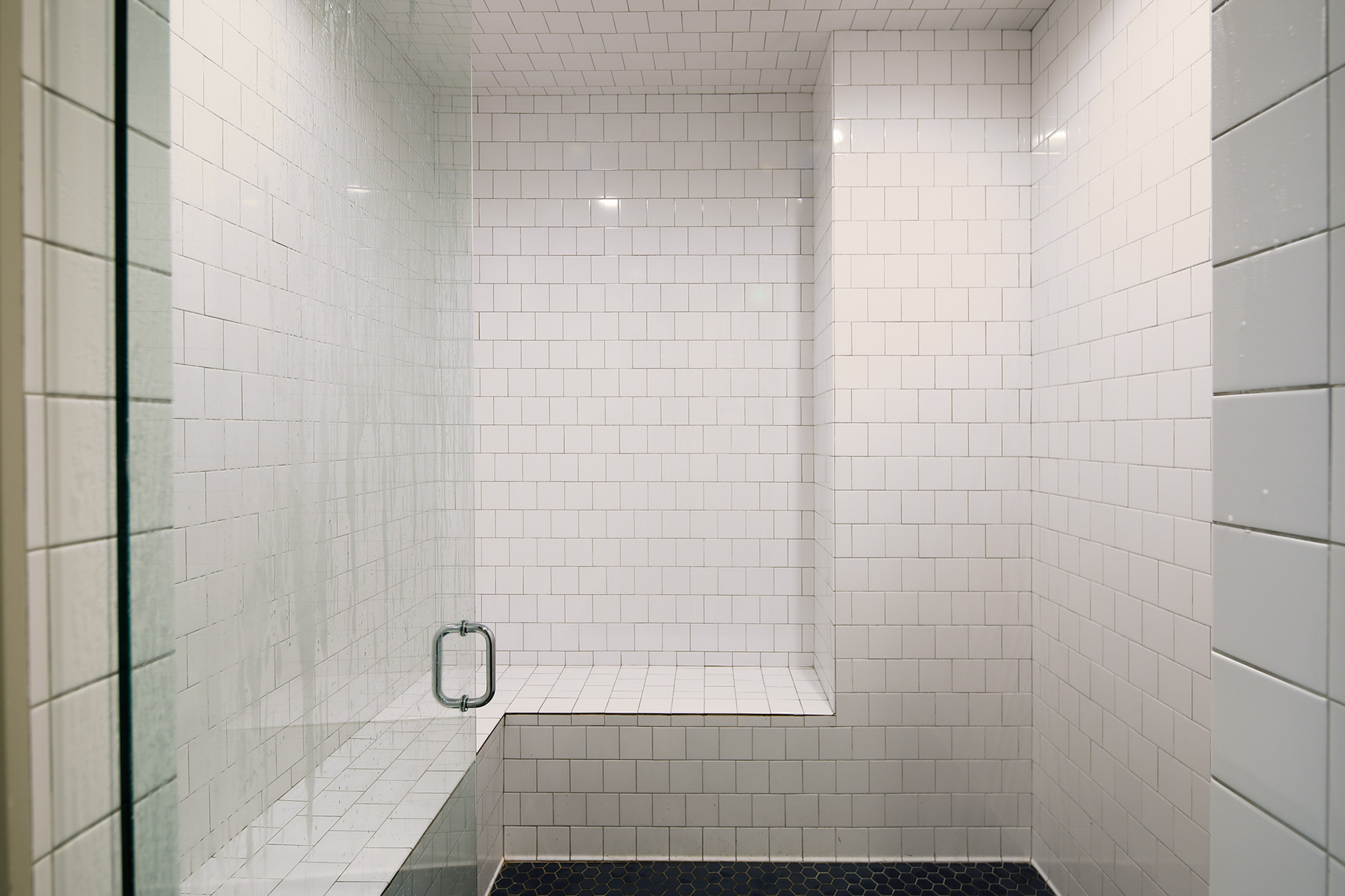 Shower with bench and white subway tile