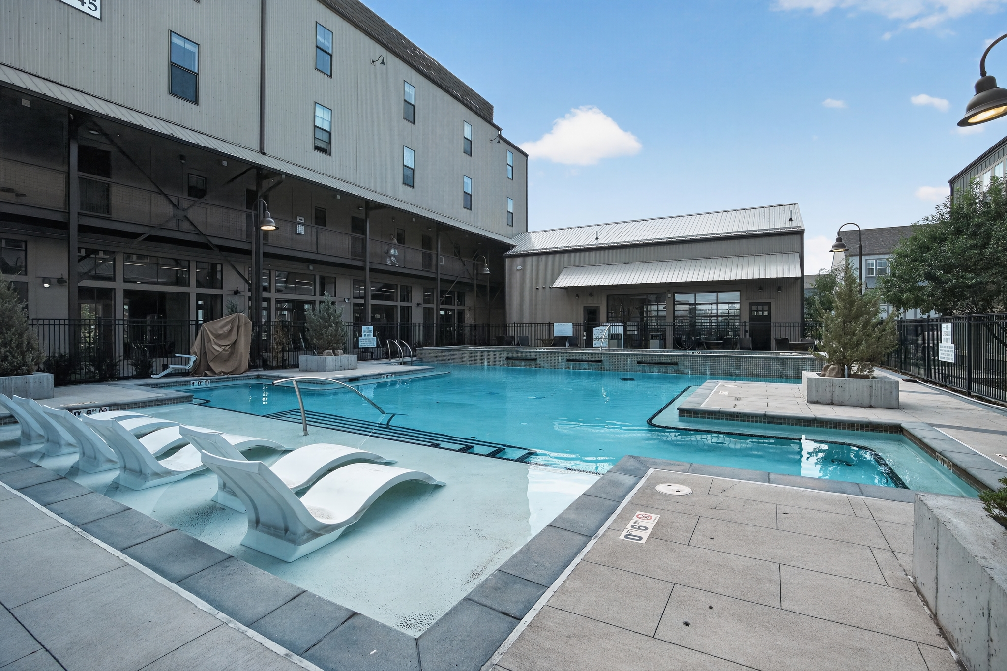 Outdoor pool with in-water sun shelf loungers